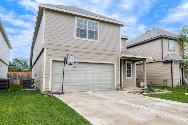 rear view of house with a lawn, a garage, fence, and concrete driveway
