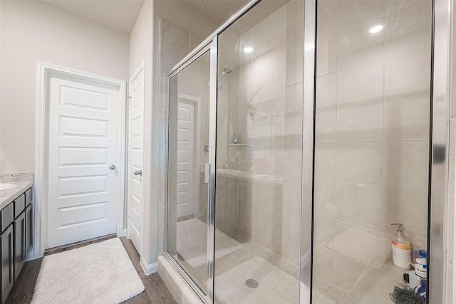 bathroom featuring vanity and a shower stall