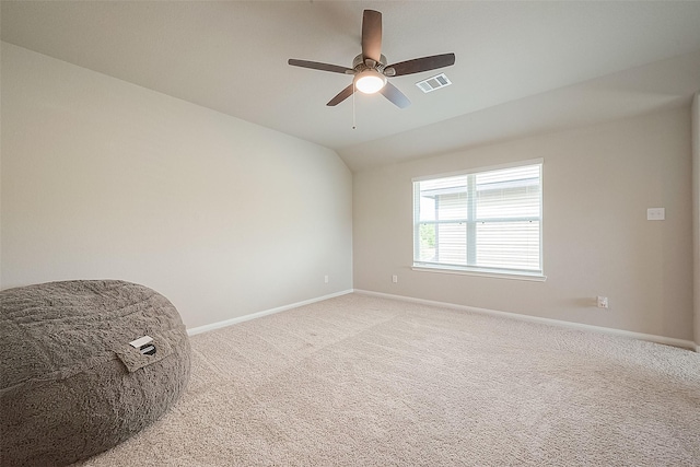 empty room with visible vents, a ceiling fan, baseboards, and light colored carpet