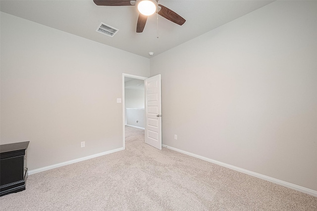 empty room with visible vents, a ceiling fan, carpet, and baseboards