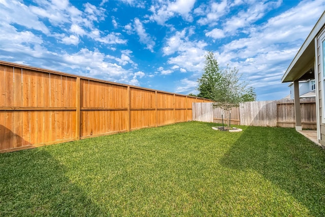 view of yard with a fenced backyard