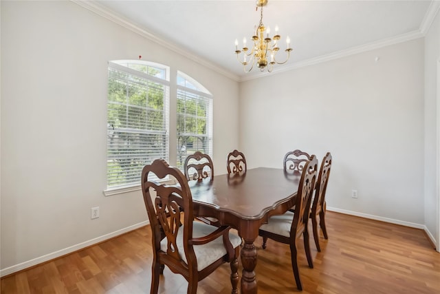 dining room featuring plenty of natural light, light wood-style flooring, baseboards, and a notable chandelier