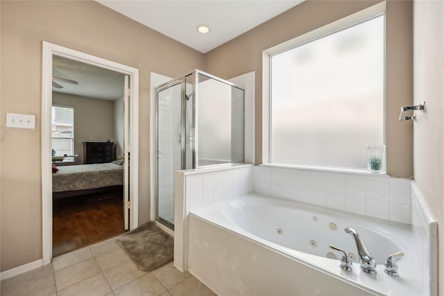 ensuite bathroom with tile patterned floors, ensuite bathroom, a shower stall, and a tub with jets