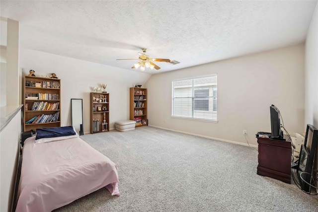 living area featuring carpet floors, a ceiling fan, a textured ceiling, and baseboards