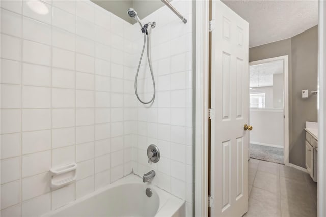full bath featuring vanity, baseboards, tile patterned flooring, and bathing tub / shower combination