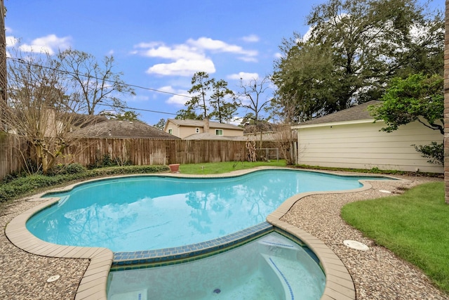 view of pool with a fenced backyard and a pool with connected hot tub