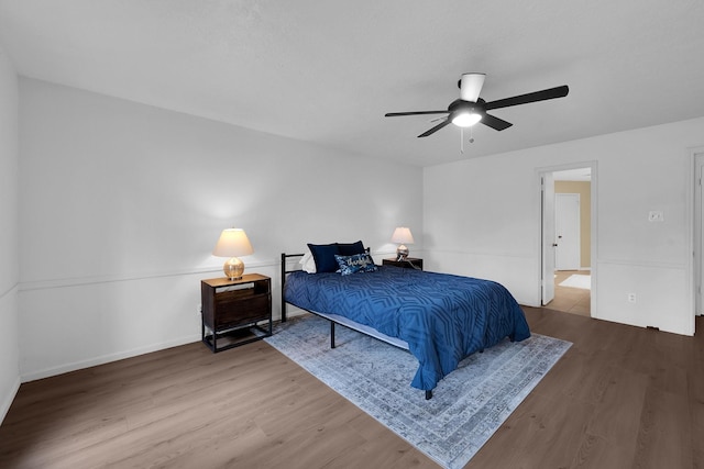 bedroom with baseboards, ceiling fan, and wood finished floors