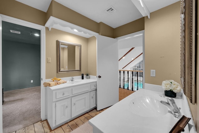 bathroom featuring visible vents, hardwood / wood-style flooring, and vanity