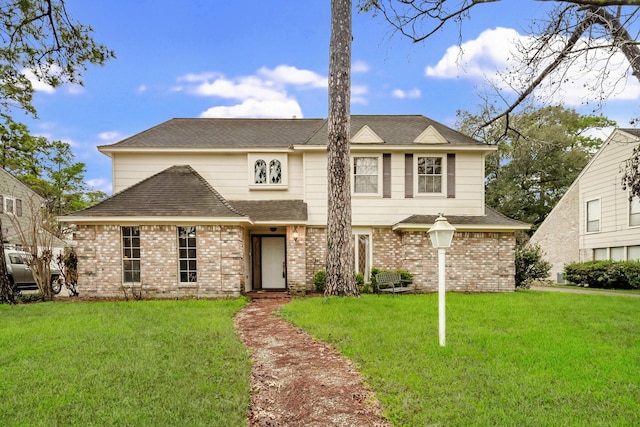 11827 Normont Dr, Houston, TX 77070 - traditional-style home featuring brick siding, a front lawn, and roof with shingles