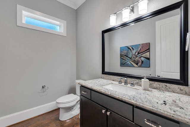 358 W 26th St, Houston, TX 77008 - half bathroom featuring baseboards, vanity, toilet, and wood finished floors