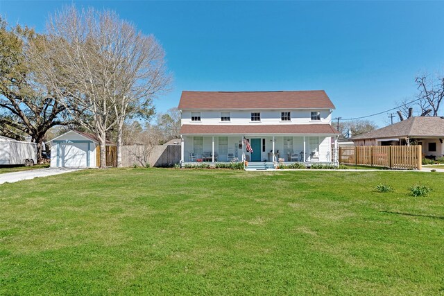 view of front of home with a garage, fence, covered porch, a front yard, and driveway