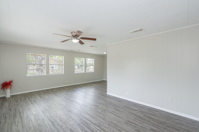spare room with baseboards, a ceiling fan, dark wood-style flooring, and visible vents