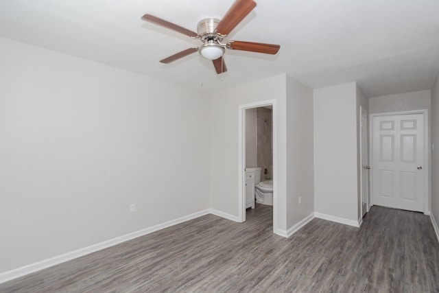 unfurnished bedroom featuring baseboards, ceiling fan, wood finished floors, and connected bathroom