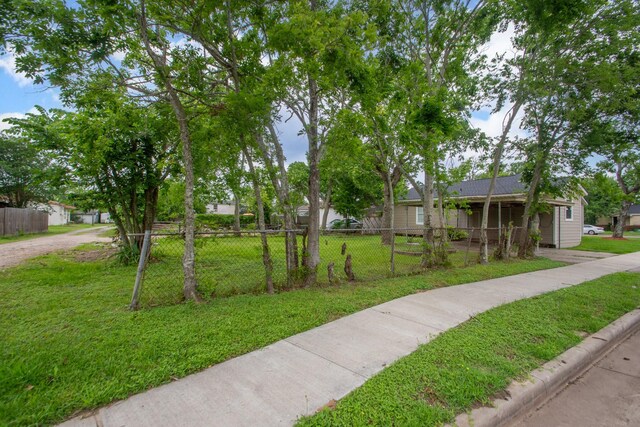 view of front of home with a fenced front yard and a front lawn