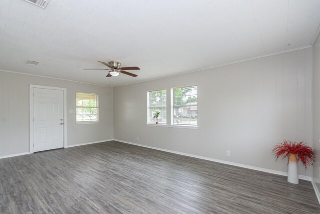 spare room featuring baseboards, a ceiling fan, and dark wood finished floors