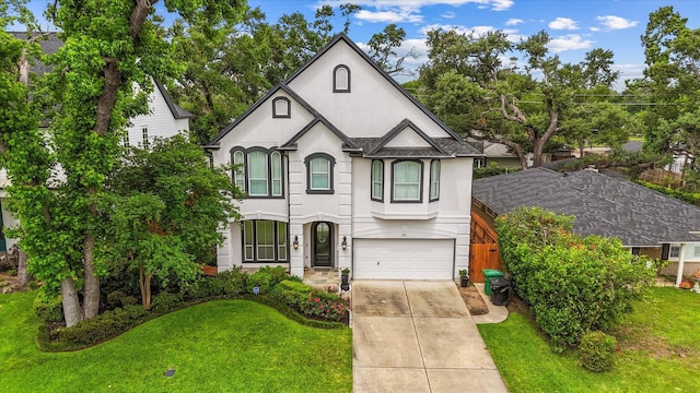 919 Worthshire St, Houston, TX 77008 - french country style house with stucco siding, a garage, driveway, and a front lawn
