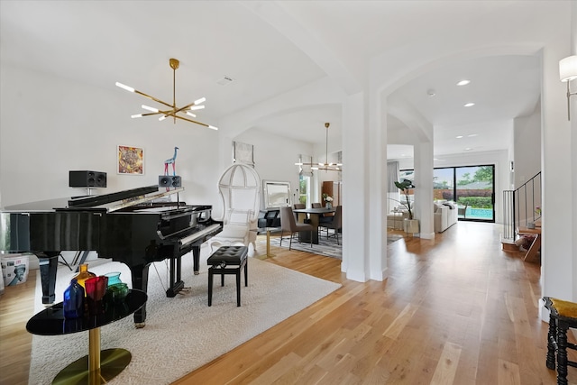 919 Worthshire St, Houston, TX 77008 - foyer entrance featuring a chandelier, light wood-style floors, recessed lighting, arched walkways, and stairs