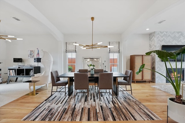 919 Worthshire St, Houston, TX 77008 - dining area featuring a chandelier, plenty of natural light, and wood finished floors