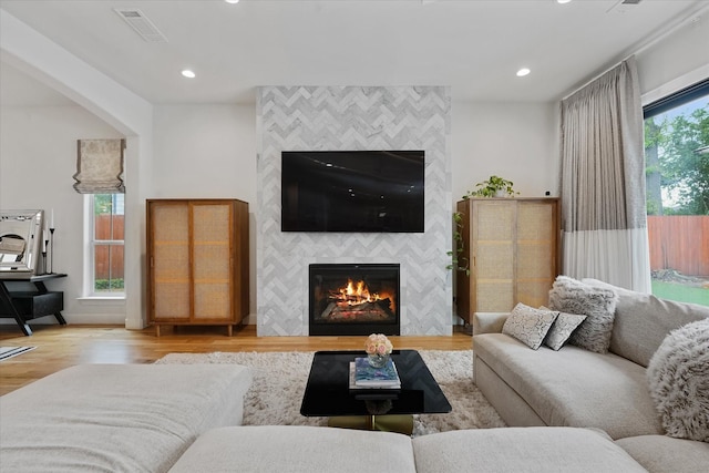 919 Worthshire St, Houston, TX 77008 - living room featuring a tile fireplace, wood finished floors, and recessed lighting