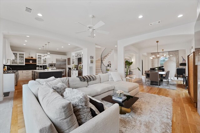 919 Worthshire St, Houston, TX 77008 - living room featuring stairway, ceiling fan, light wood-type flooring, a chandelier, and recessed lighting