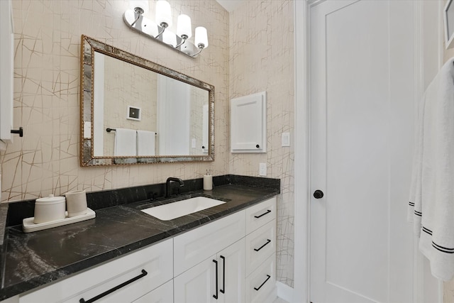 919 Worthshire St, Houston, TX 77008 - bathroom featuring vanity, tile walls, and backsplash