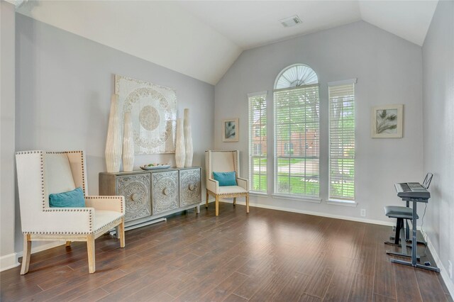 sitting room featuring baseboards, visible vents, wood finished floors, and lofted ceiling