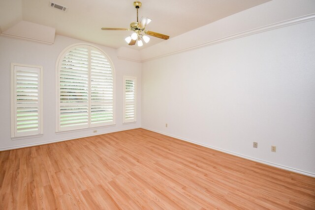 spare room featuring visible vents, light wood-style flooring, ceiling fan, and baseboards