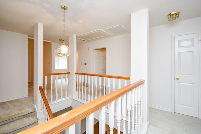 6007 Gideon Ct, Sugar Land, TX 77479 - hall with light carpet, attic access, baseboards, an upstairs landing, and visible vents