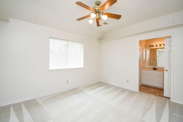 6007 Gideon Ct, Sugar Land, TX 77479 - unfurnished bedroom with light colored carpet, a sink, baseboards, lofted ceiling, and ensuite bath
