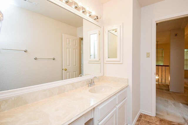 bathroom with vanity, baseboards, and visible vents