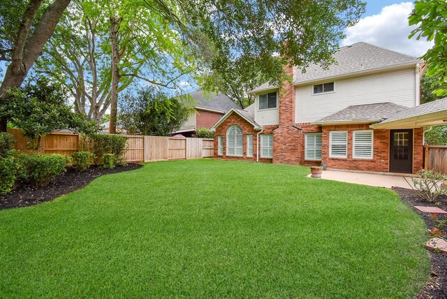 view of yard with a fenced backyard and a patio area