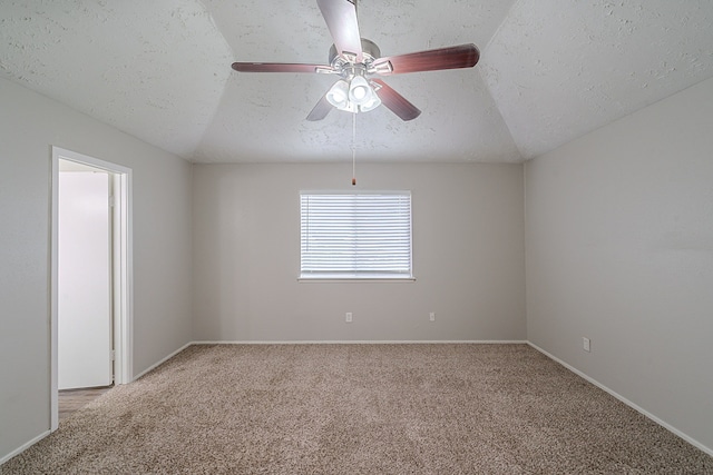 20211 Big Timber Ct, Humble, TX 77346 - empty room with light colored carpet, a textured ceiling, ceiling fan, vaulted ceiling, and baseboards
