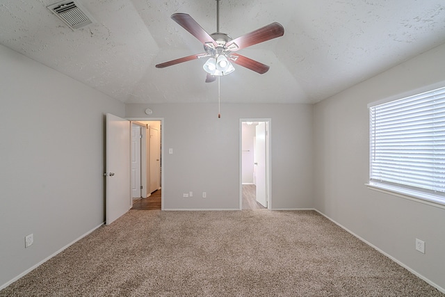 interior space featuring visible vents, carpet flooring, baseboards, and a ceiling fan