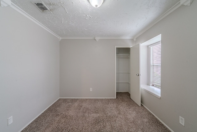 unfurnished bedroom featuring crown molding, a closet, carpet flooring, and a textured ceiling