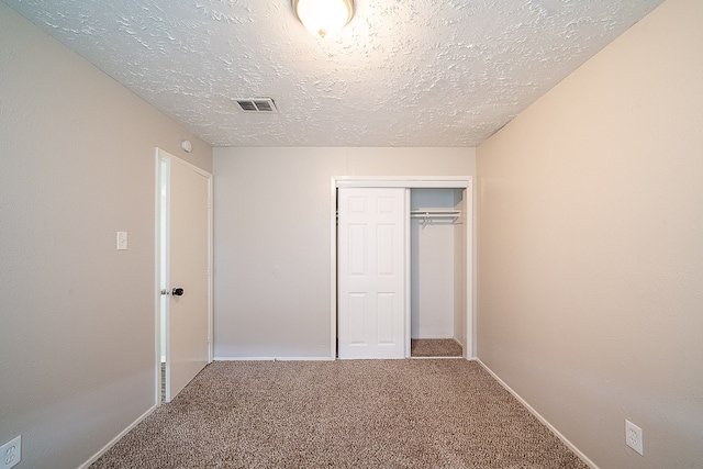20211 Big Timber Ct, Humble, TX 77346 - unfurnished bedroom with carpet floors, a textured ceiling, a closet, and baseboards