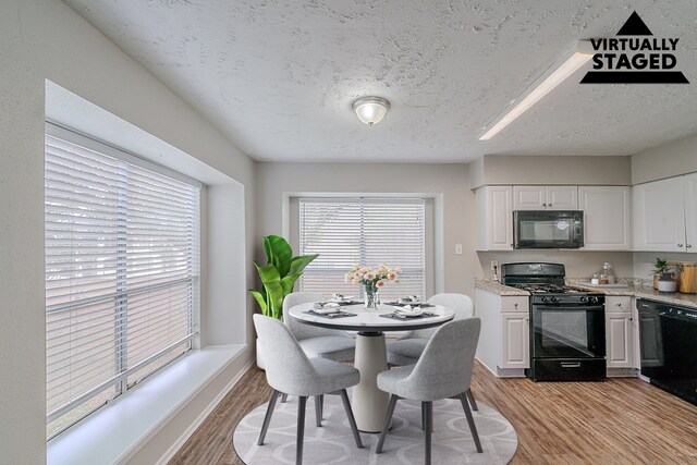 20211 Big Timber Ct, Humble, TX 77346 - dining room with light wood-style floors and a textured ceiling