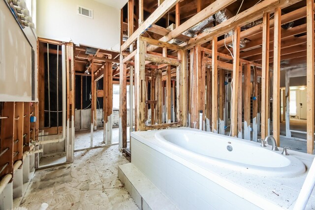 full bathroom with visible vents and a garden tub