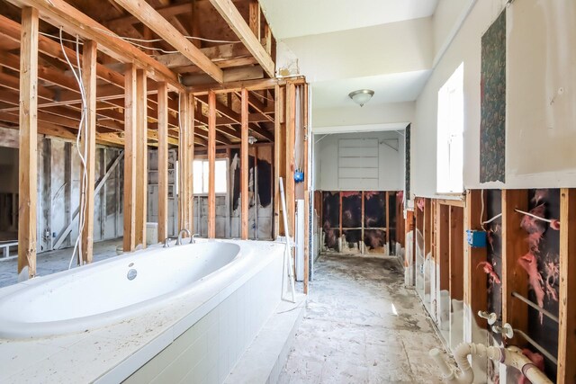 bathroom featuring plenty of natural light and a garden tub