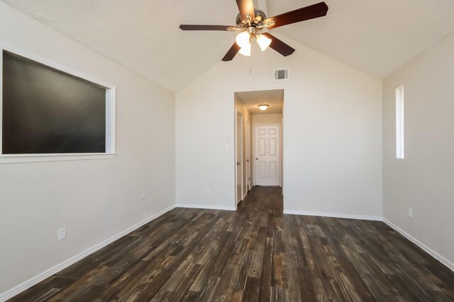 empty room with visible vents, a ceiling fan, lofted ceiling, and wood finished floors