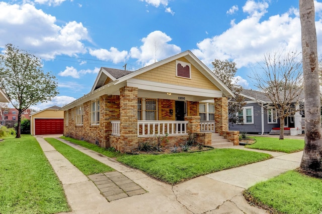 1106 Key St, Houston, TX 77009 - view of front of property with covered porch, a detached garage, a front yard, an outdoor structure, and brick siding