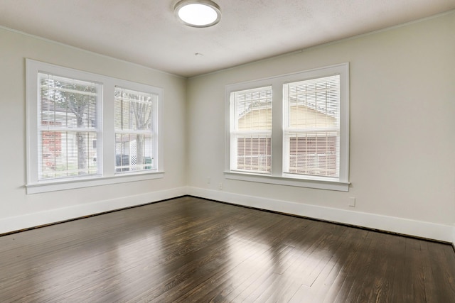 1106 Key St, Houston, TX 77009 - spare room featuring healthy amount of natural light, dark wood-type flooring, baseboards, and ornamental molding