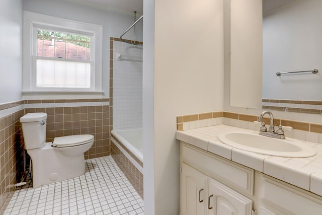 1106 Key St, Houston, TX 77009 - bathroom with vanity, toilet, bathtub / shower combination, tile walls, and tile patterned floors