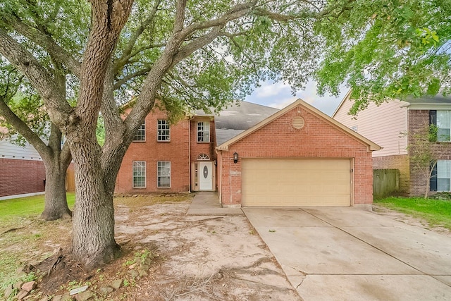 view of front of home with concrete driveway, brick siding, and a garage