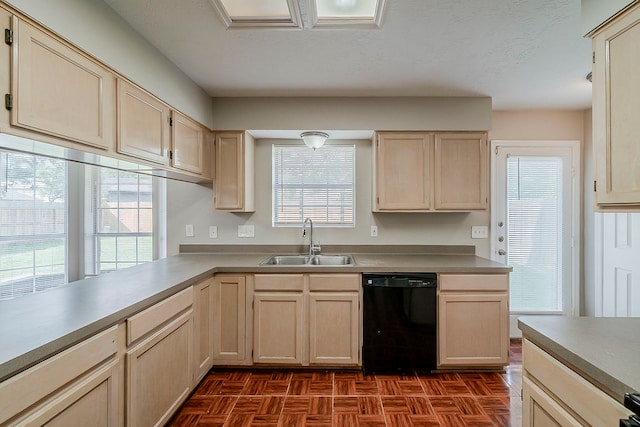 kitchen with a sink, light brown cabinetry, light countertops, and dishwasher