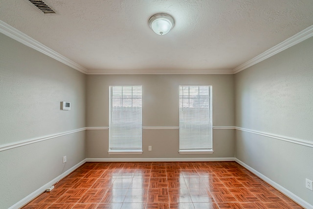 unfurnished room with baseboards, a textured ceiling, and visible vents