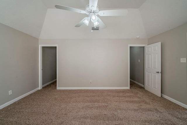 unfurnished bedroom featuring baseboards, carpet, lofted ceiling, and visible vents
