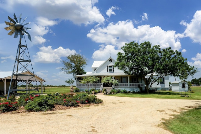 exterior space featuring a lawn and dirt driveway