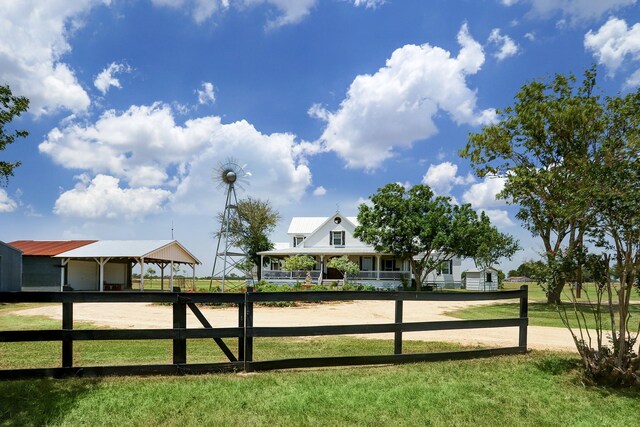 view of gate featuring a yard and an outdoor structure
