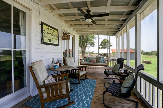 sunroom featuring ceiling fan