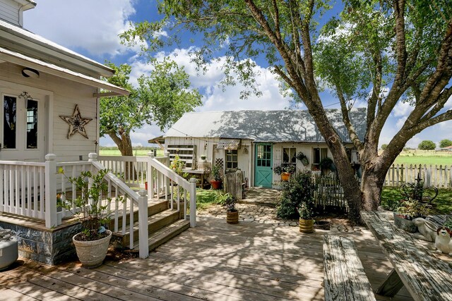 view of patio / terrace featuring fence and a deck